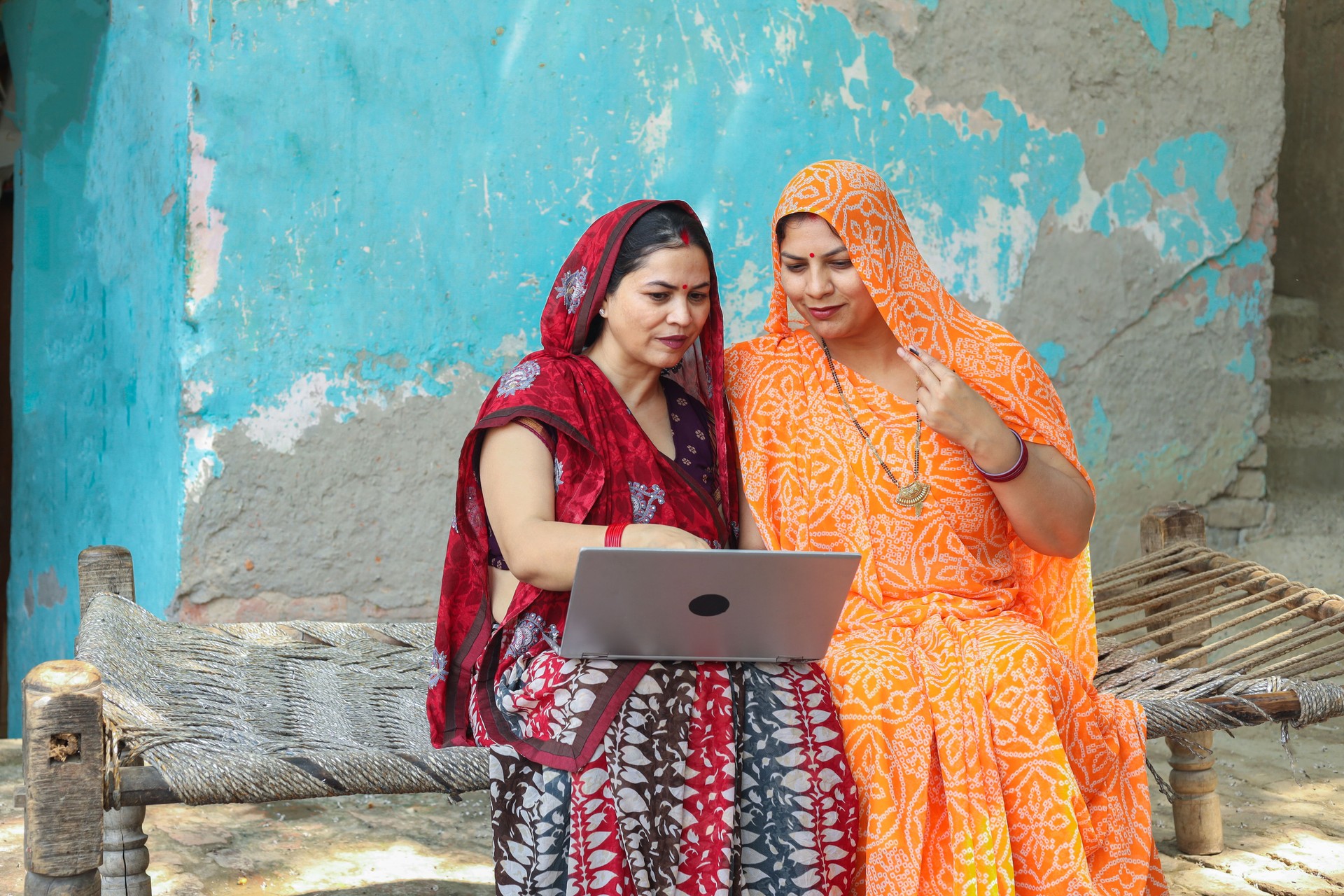 Rural indian women using laptop or learning computer together. Digital india. Wireless technology.